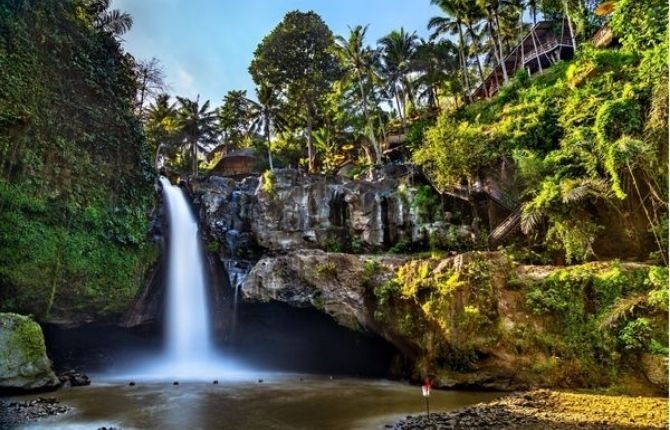 Scenic view of Tegenungan Waterfall surrounded by tropical jungle in Bali